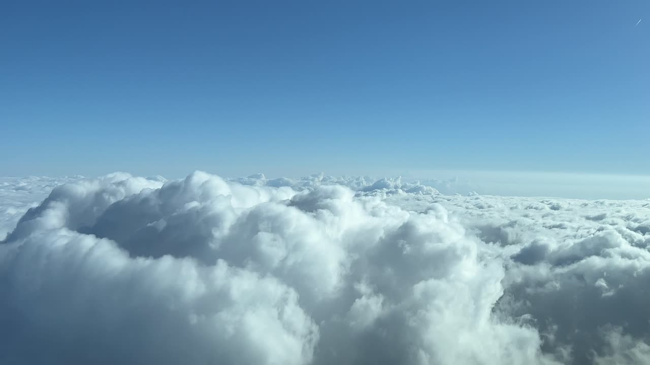 A pilot&rsquo;s perspective of a stormy spring sky full of clouds whe overflying some cumulus