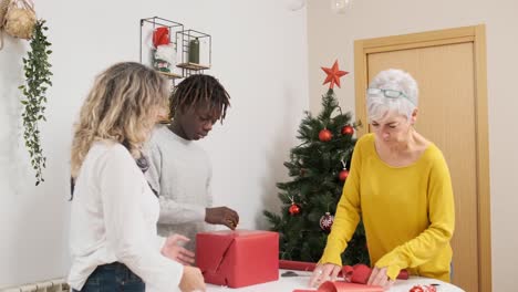 family wrapping christmas gifts