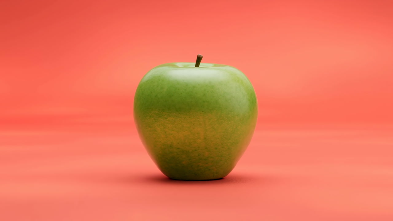 Fresh Green Apple Isolated on a Red Studio Background