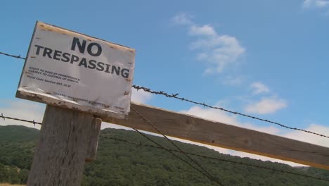 Time-lapse-of-clouds-drifting-past-a-no-trespassing-sign-1