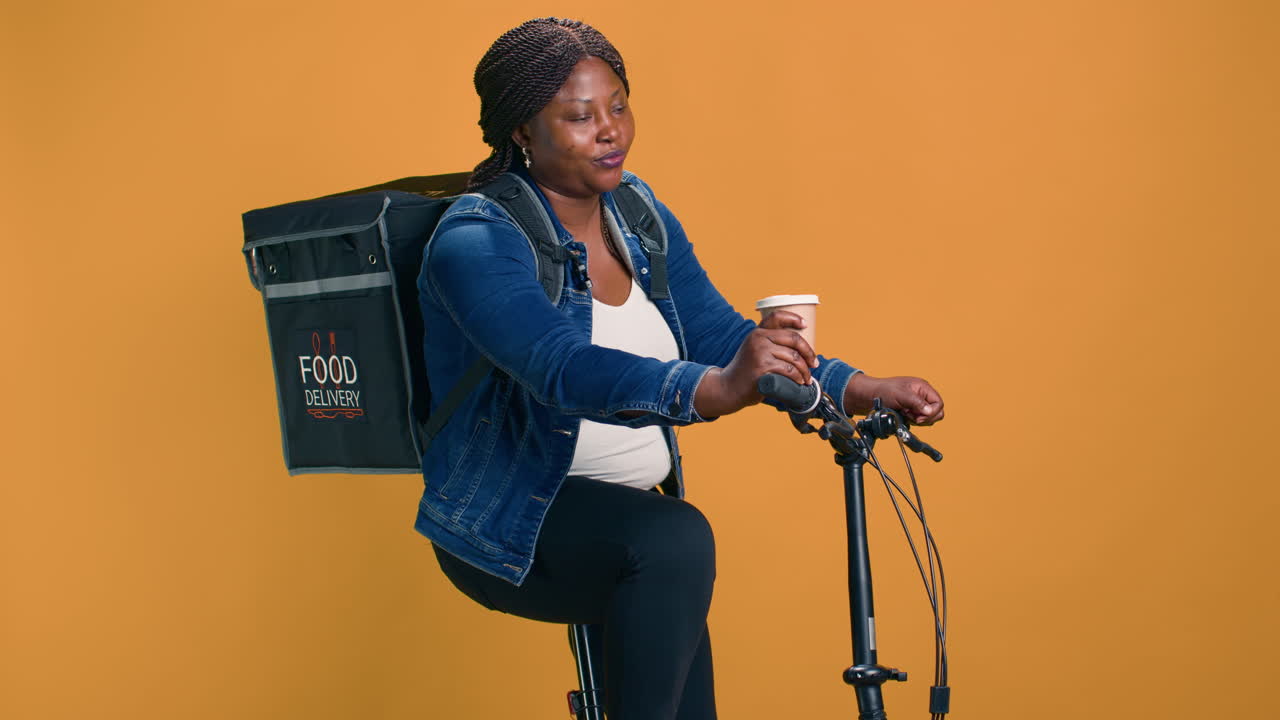 Woman On Bicycle With Coffee In Her Hand