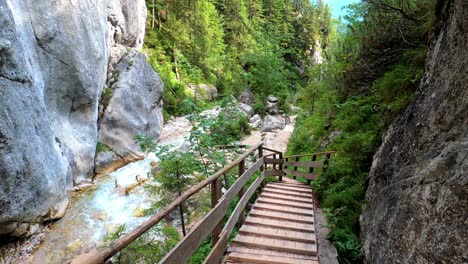 POV-shot-of-someone-walking-down-wooden-stairs-in-a-beautiful-canyon