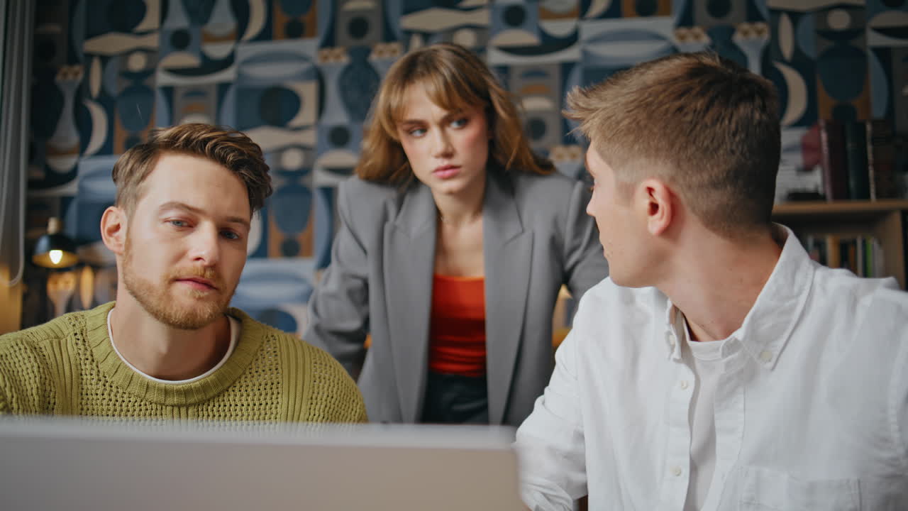 Group businesspeople discussing together watching computer at office closeup