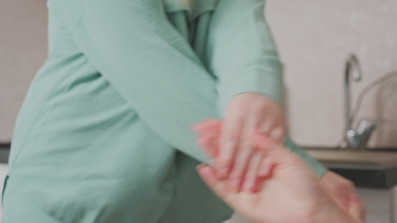 hands of two girls meet in playful gesture during lighthearted moment in kitchen, capturing emotional connection and joy of friendship through expressive movement and interaction