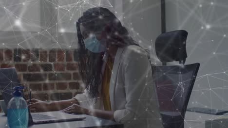 Animation-of-network-of-connections-over-woman-in-office