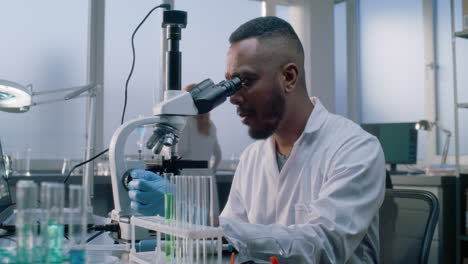 scientist using a microscope in a laboratory