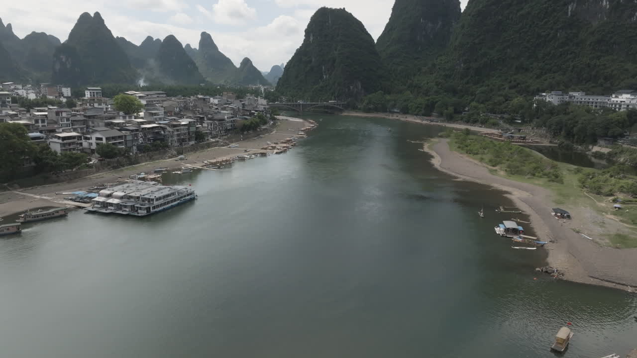 Aerial ascending shot of the Li river in Yangshuo village, summer day in China
