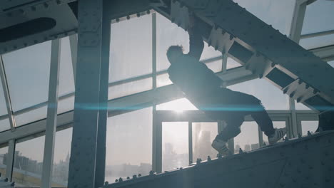 man climbing a metal bridge structure