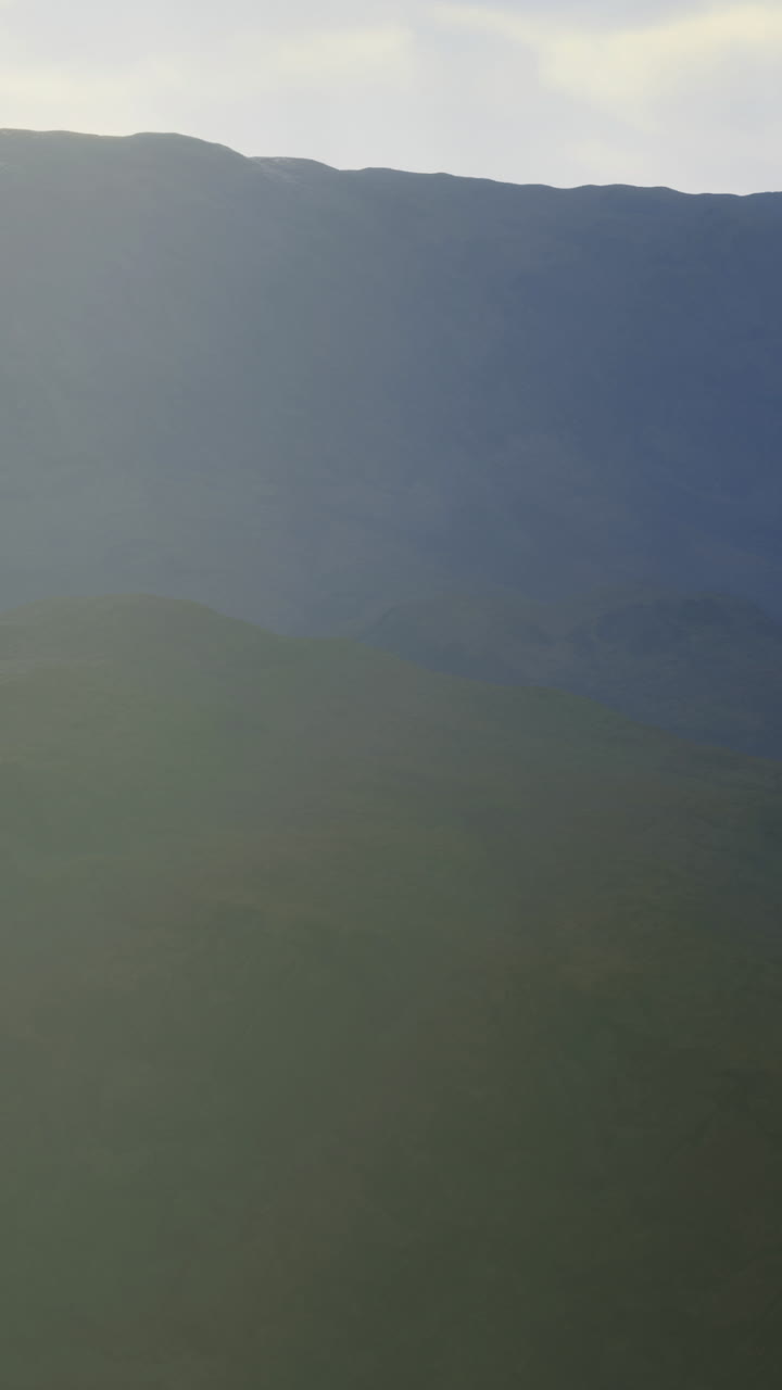 Majestic mountain range bathed in soft morning light showcases natures beauty