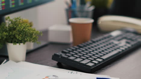 company files and coffee on table in accounting office, close up