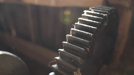 Old-rusted-machine-cog-wheel-in-orbit-shot-in-low-sunlight