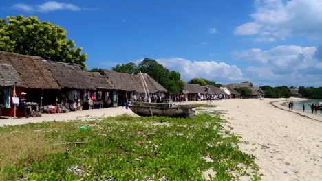 pan right shot over local bungalow shops, and local stores on the beach side in zanzibar, africa