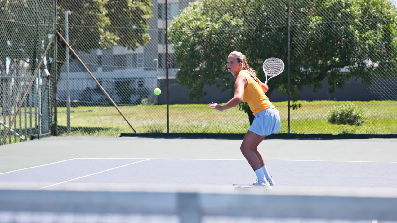 Young Woman Playing Tennis and Hitting a Forehand Shot on Court