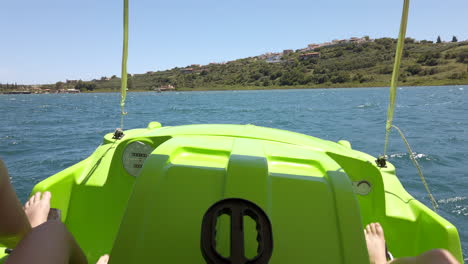 Wide-Shot-of-a-Couple-Peddling-a-Pedalo-Across-a-Choppy-Kournas-Lake-in-Crete,-Greece-on-a-Clear-Sunny-Day