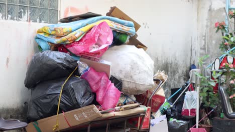 person unloads trash bags from overloaded cart