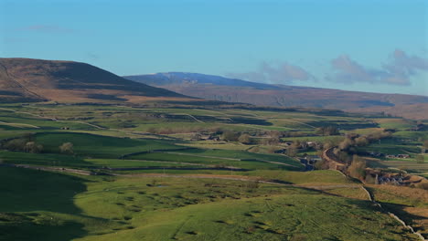 establishing aerial shot of hilly fields yorkshire dales with whernside