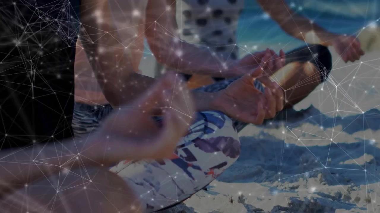 Camera dollying in focusing on mudra as three women meditating on sand for wellness