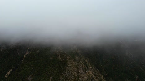 Mystical-Winter-Landscape-as-Clouds-and-Fog-Envelop-the-Majestic-Mountain-Peaks-in-a-Dramatic-Dance