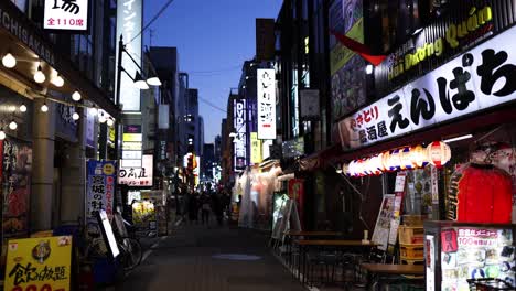 pedestrians walking through a lively japanese street