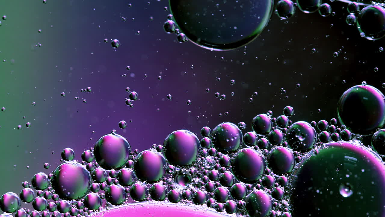 Mixing Bubble of Water and Oil, Colored in Pink Purple and Green, Abstract Background