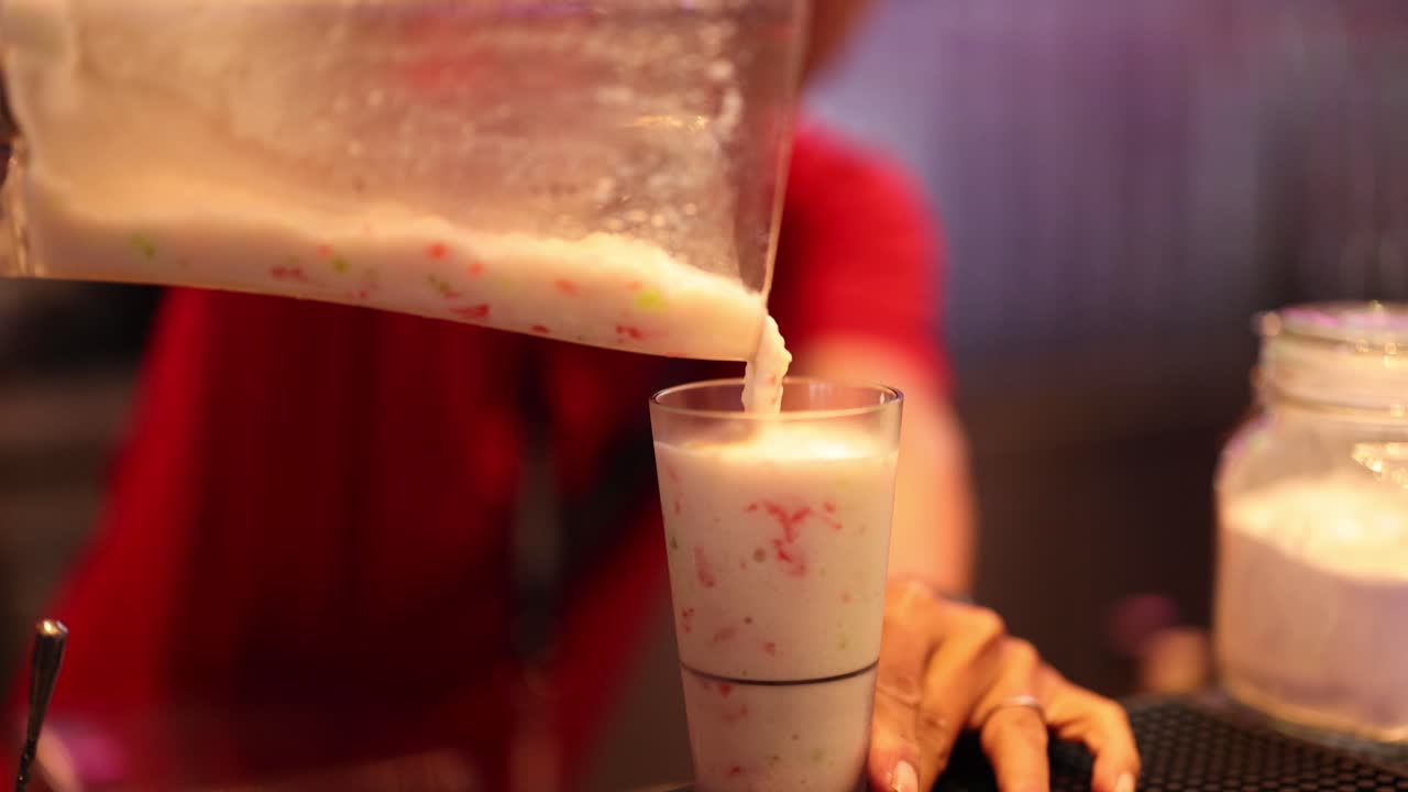 Pouring smoothie into a glass in Bangkok