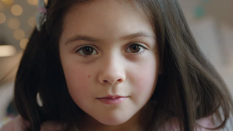 portrait beautiful little girl looking at camera happy child at home in bedroom