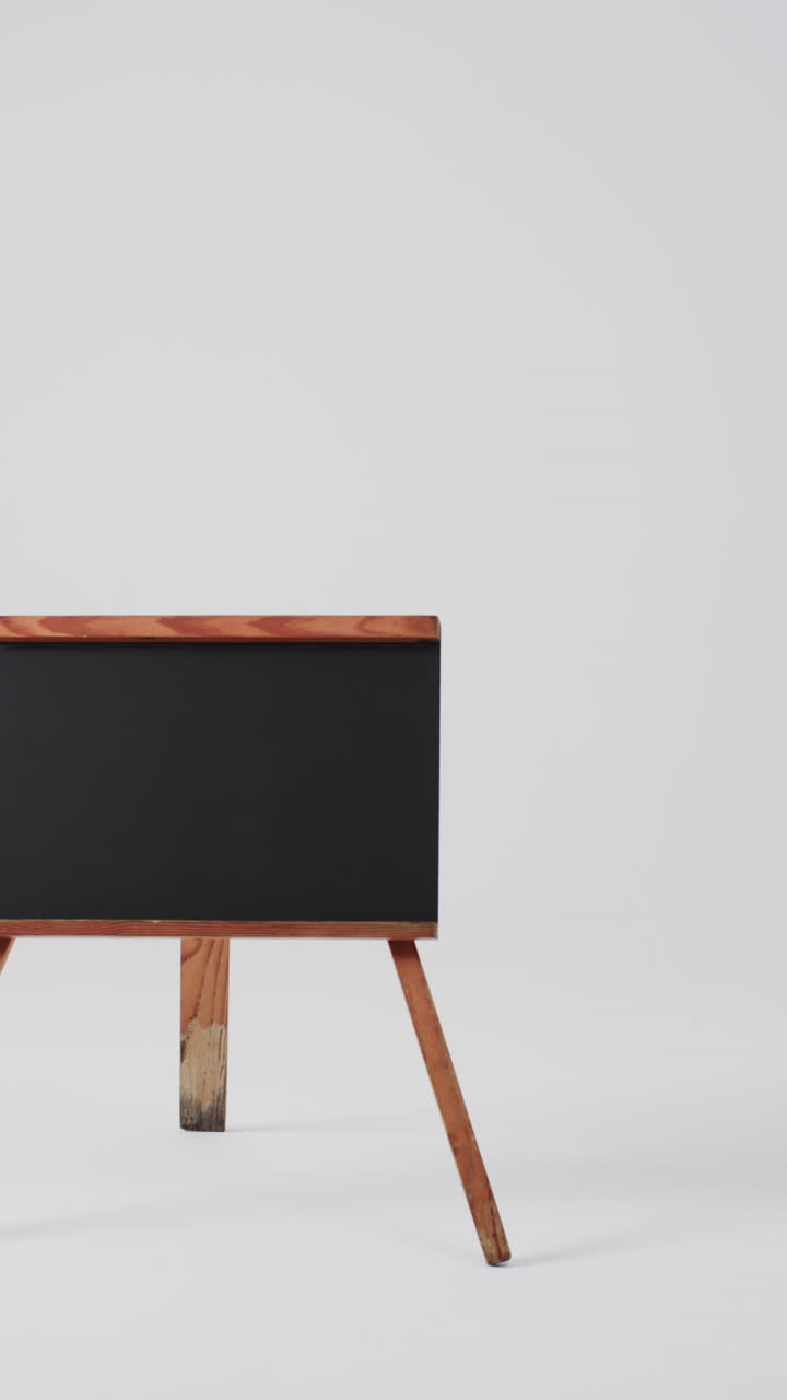 Vertical video of blackboard sign on wooden stand with copy space on white background