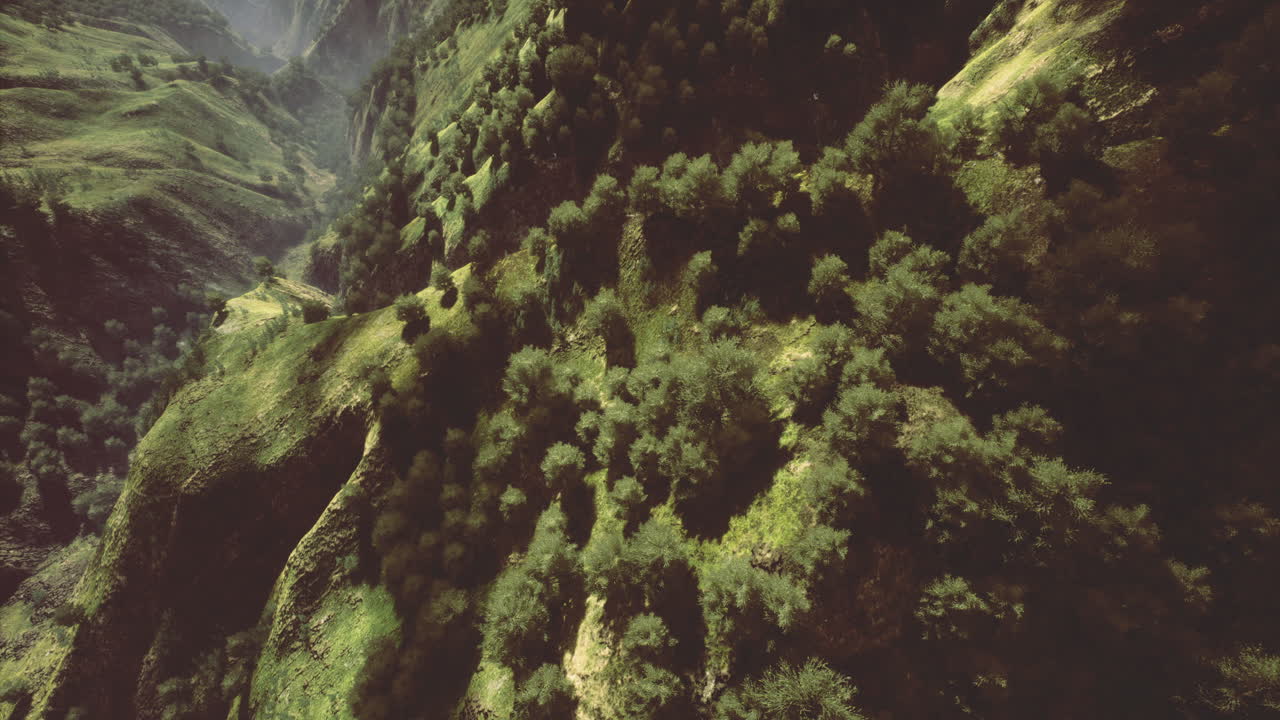 Lush green hills with winding pathways in a serene mountain landscape