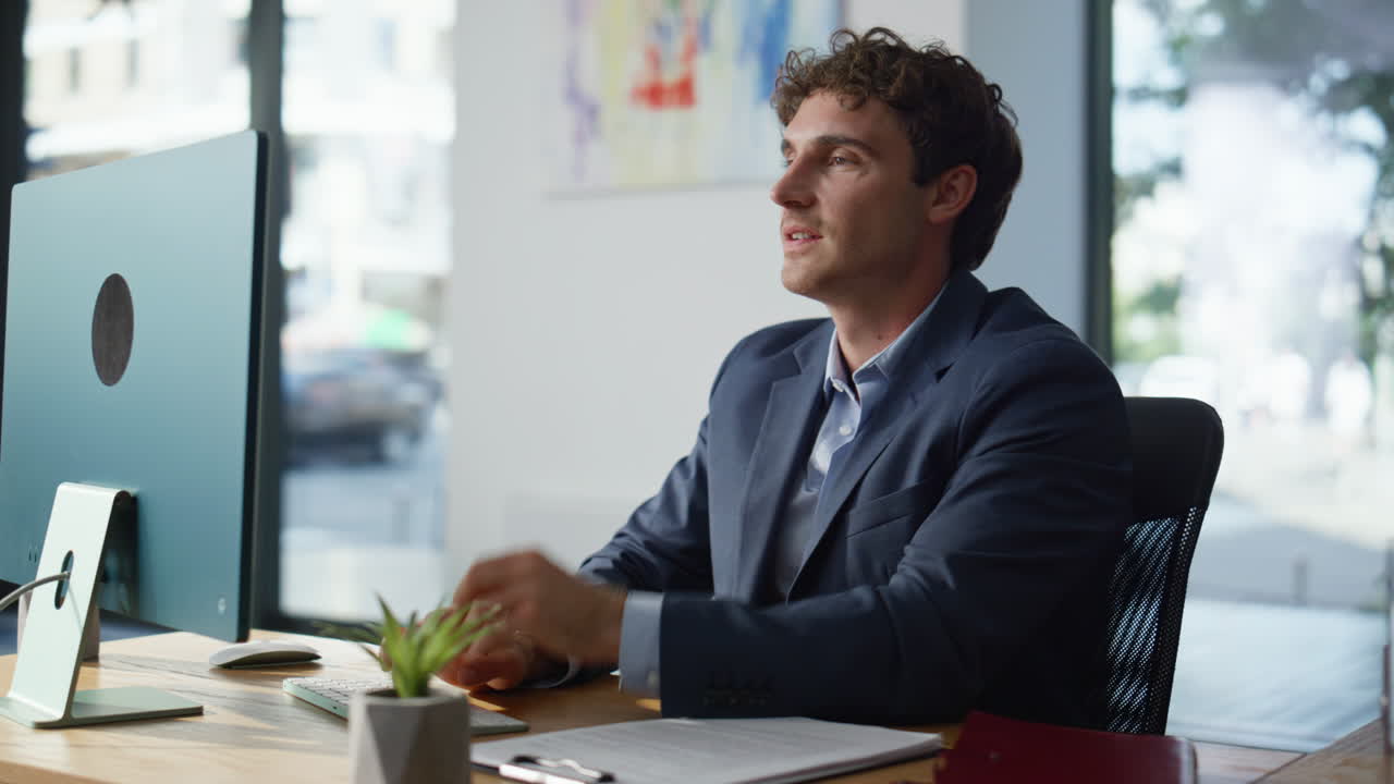 Smiling employee reviewing papers at modern coworking space closeup. Man texting