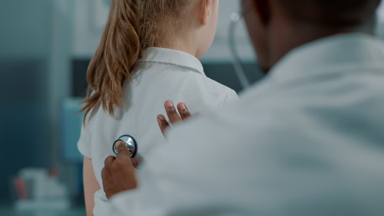 Doctor examining child with stethoscope