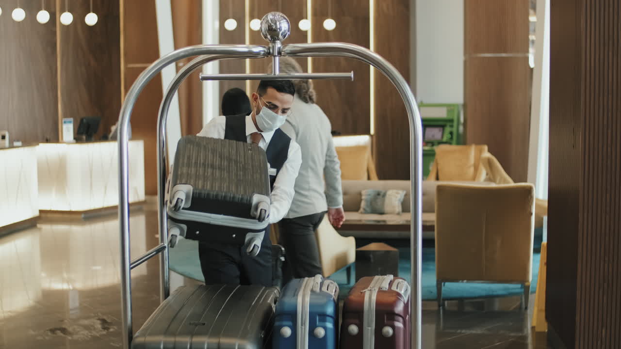 Guests Giving Luggage to Porter in Lobby