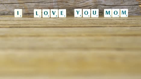 i love you mom block on wooden background