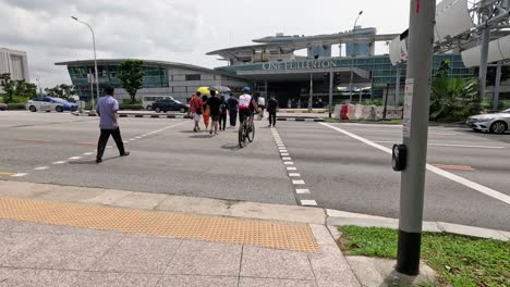 people crossing a crosswalk at one fullerton, singapore