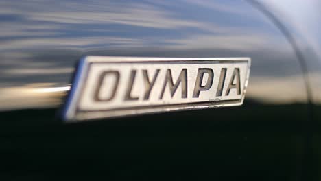 opel olympia classic car logo emblem macro shot on a slider, 50 fps slow motion