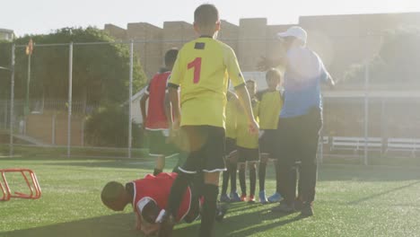 soccer kids gathering in cercle in a sunny day