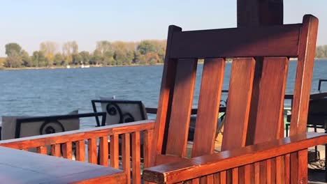 wooden chair in focus with danube river in background