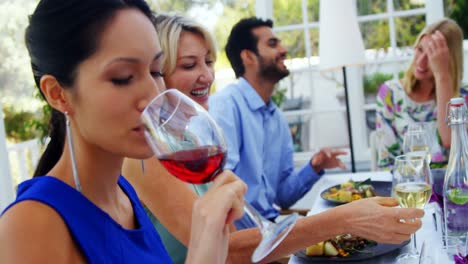 woman having glass of red wine