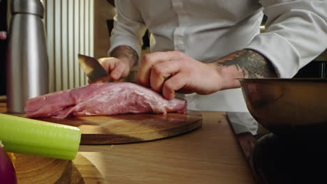 chef preparing a meat dish with fresh vegetables