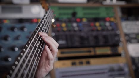 close up shot of ambitious musician holding a bass guitar in his hands