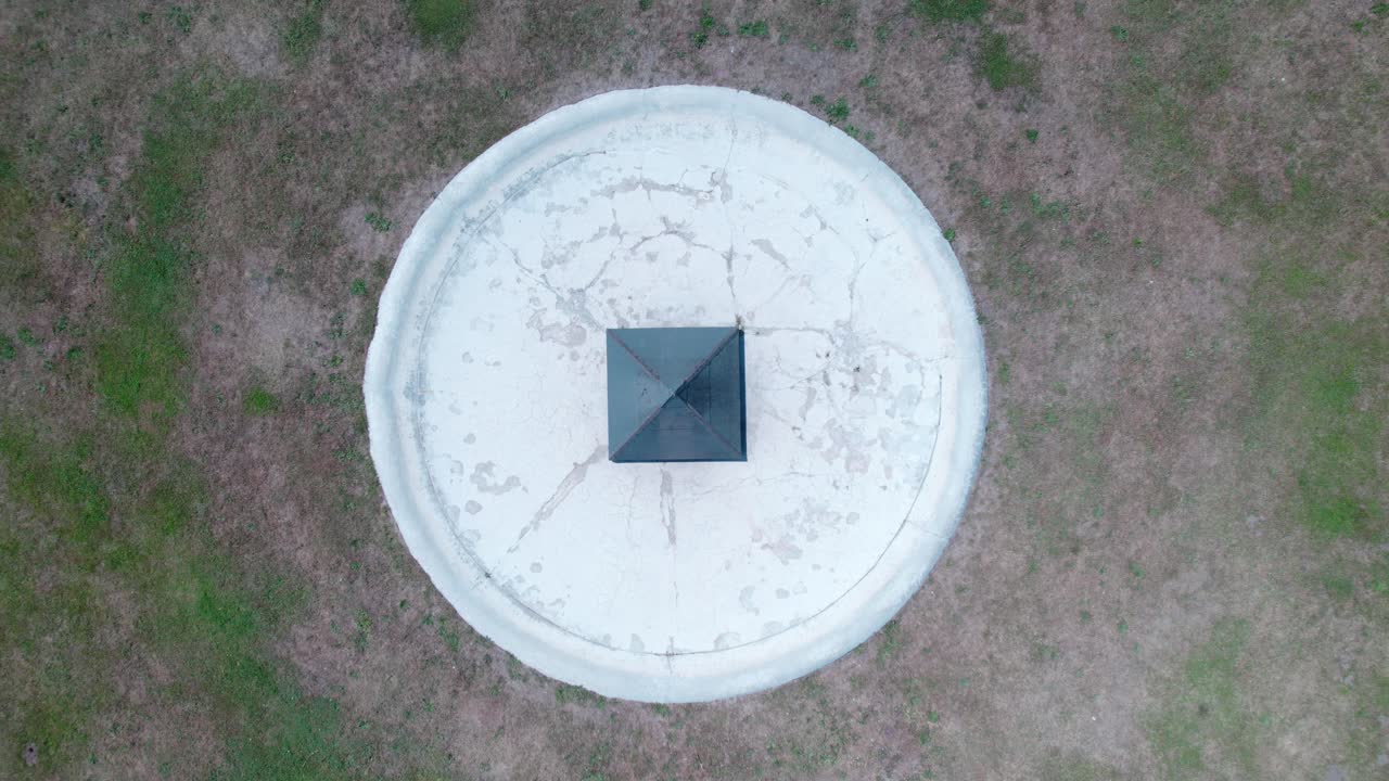 уменьшенное изображение металлической пирамиды посреди бесплодной травы рядом с дворцом зондерсхаузен