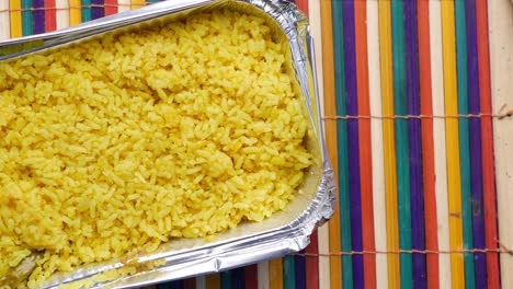 yellow rice in foil container