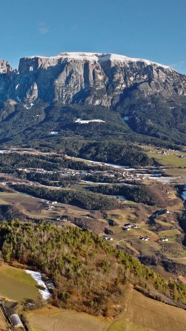 Aerial drone view of the Soprabolzano village on the Renon plateau in the Dolomites, Italy. Vertical
