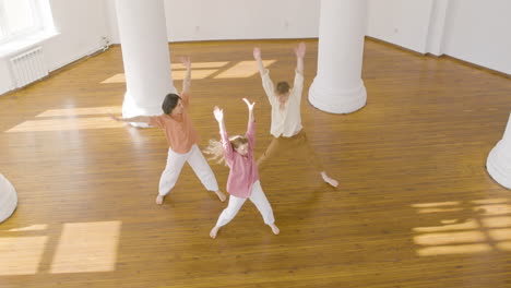 top view of multiethnic group of contemporary dancers dancing and moving around the studio