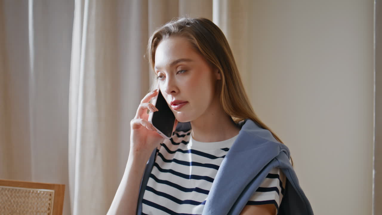 Casual lady speaking smartphone in sunlit home closeup. Manager consulting