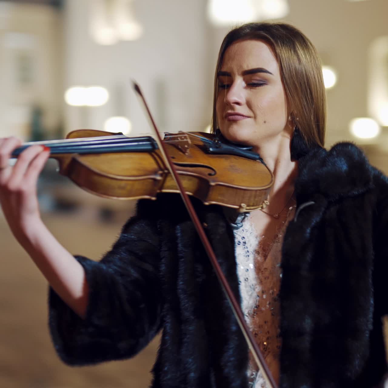 Young girl playing violin outdoors