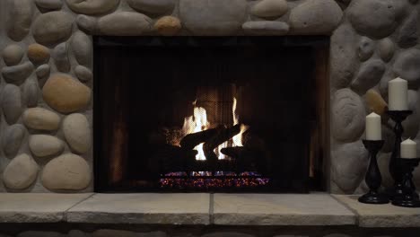 cozy fireplace with stone surround and candles