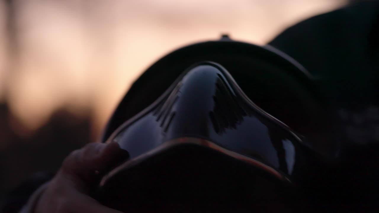 A close-up of a firefighter's helmet at sunset
