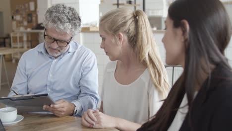 insurance agent and customers meeting in co-working space