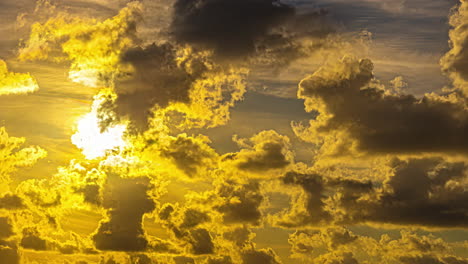 fluffy clouds illuminated by golden yellow sunlight at sunset