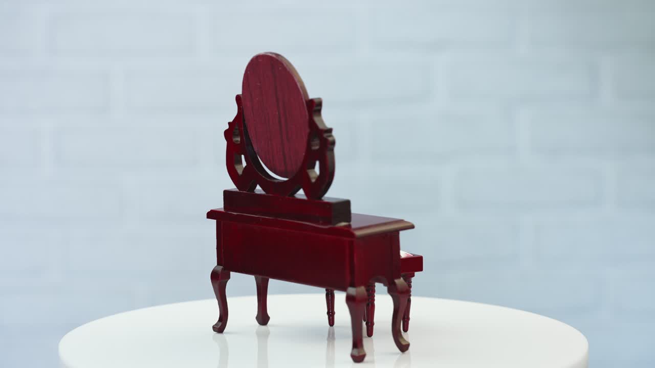 Beautiful wooden nightstand and little stool at the rotating table. Adorable pieces of furniture at white backdrop.